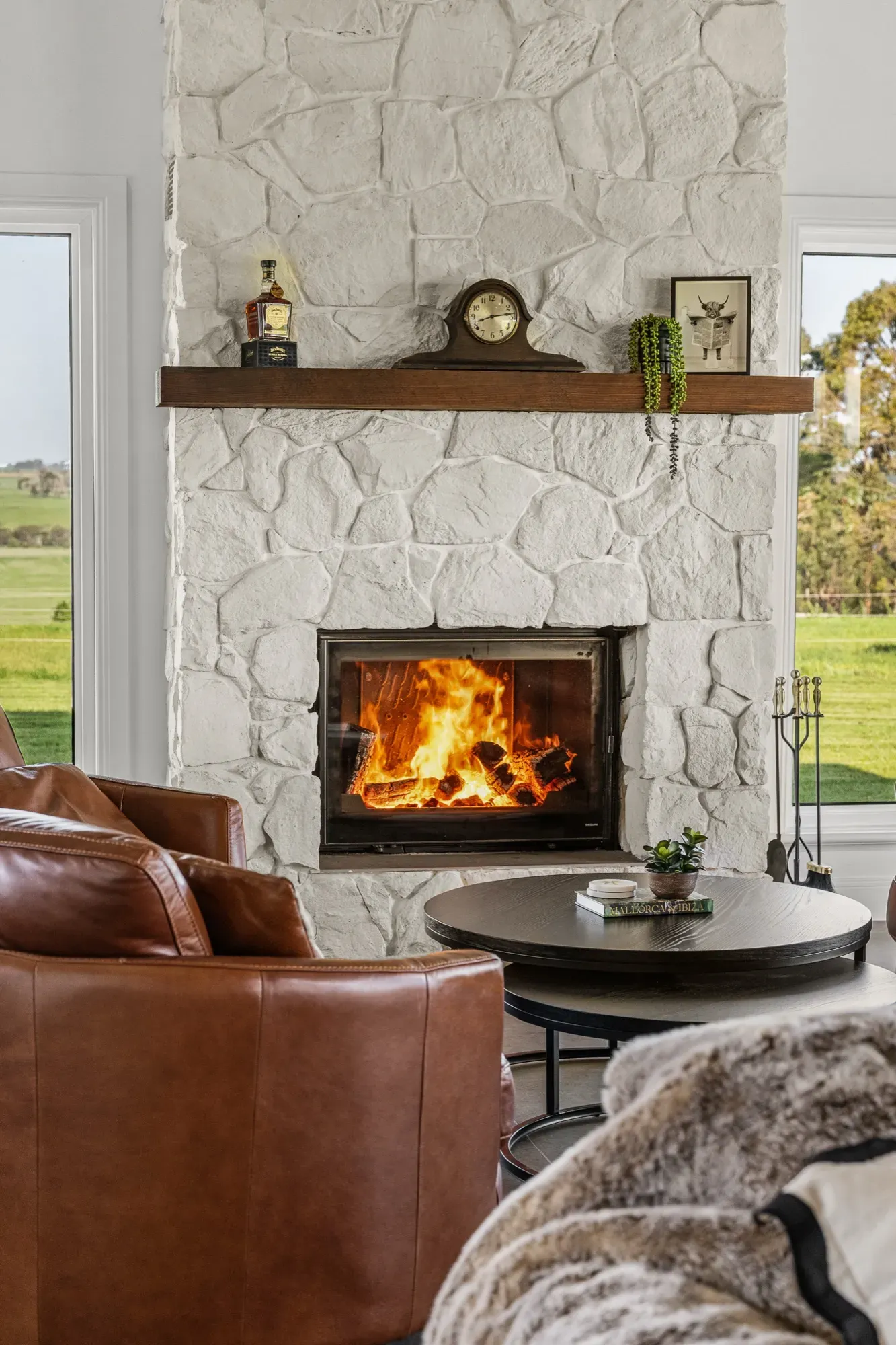 Stone fireplace with fire lit