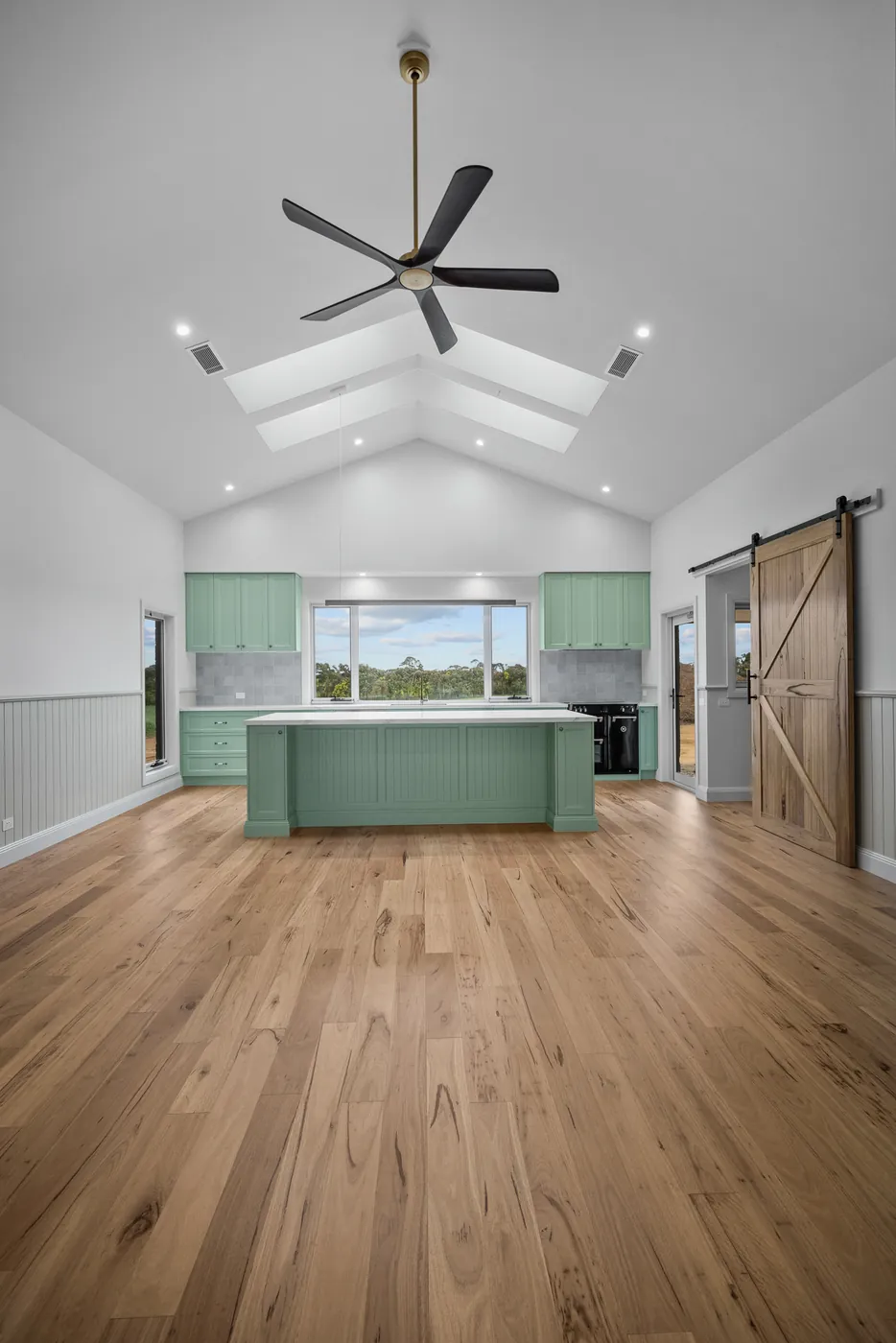 Open living at Hallowells Homestead, with skylights in the raked ceiling and VJ panelling to the walls