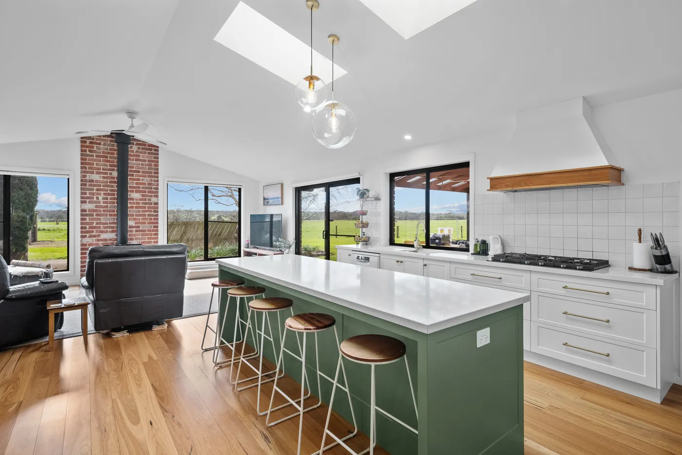 The kitchen and living extension at Sawmiller's Cottage, under a raked ceiling with skylights