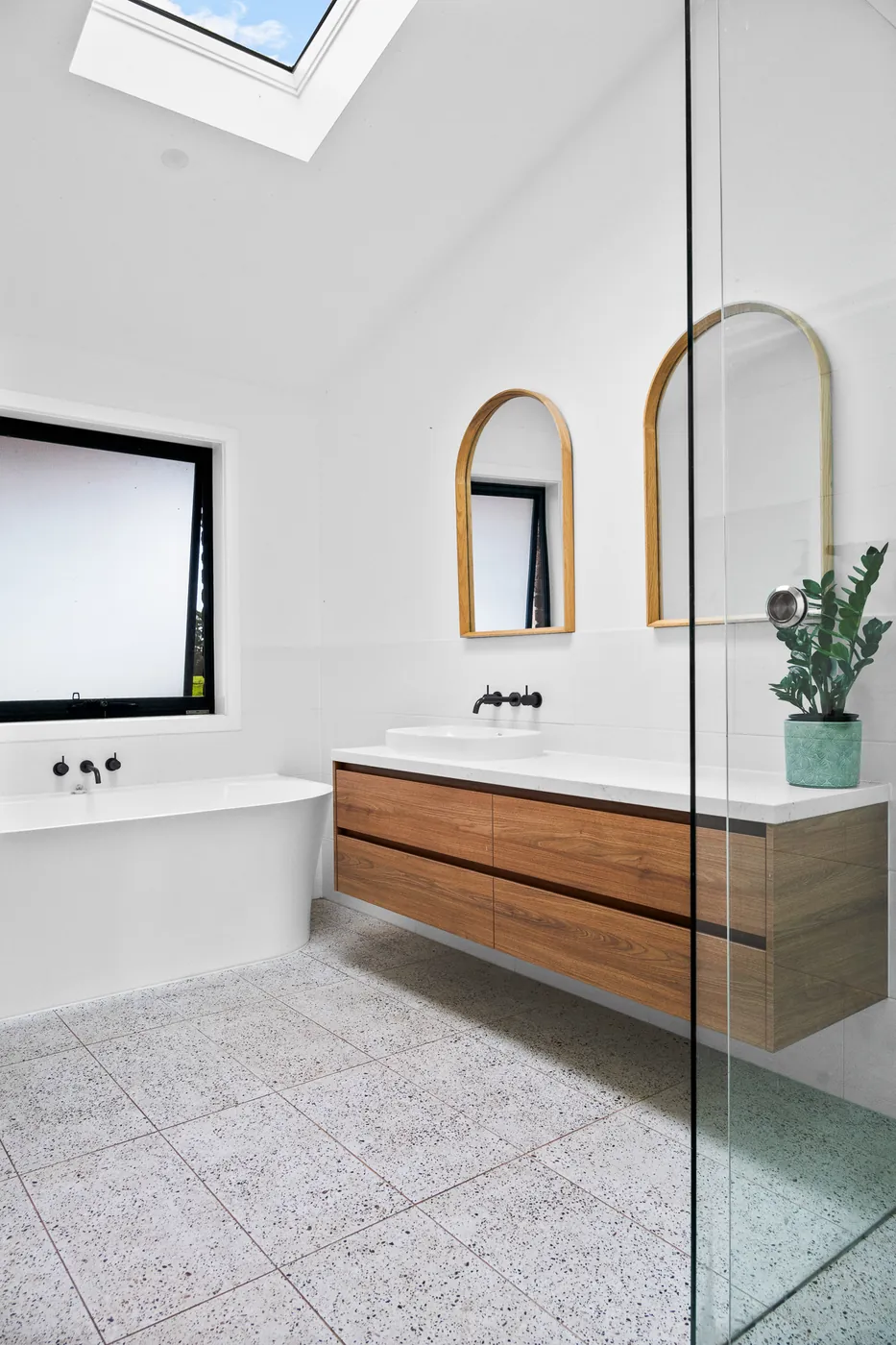The ensuite at Sawmiller's Cottage, with a skylight over the freestanding bath